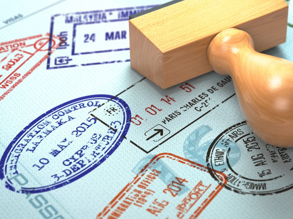 Close-up of a passport with multiple immigration stamps, symbolizing business consultancy services in Dubai for visa and legal processes.